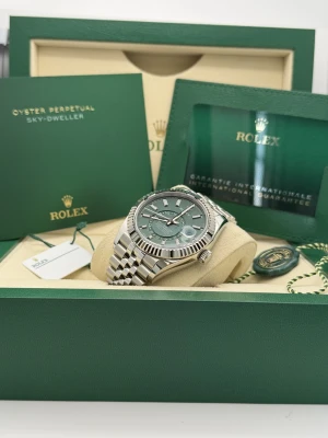 Rolex Sky-Dweller 42mm, 336934, mint green dial, white gold fluted bezel, stainless steel jubilee bracelet.2026 unworn